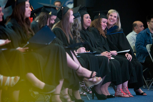 School of Business instructor Karen Okun, right, hugs a student during a Convocation Ceremony at Capilano University on Tuesday, June 5, 2018.