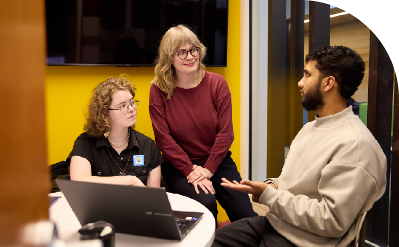 Faculty member meeting with students