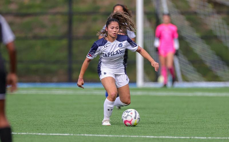 Alexis King carries the ball through the Capilano Blues midfield