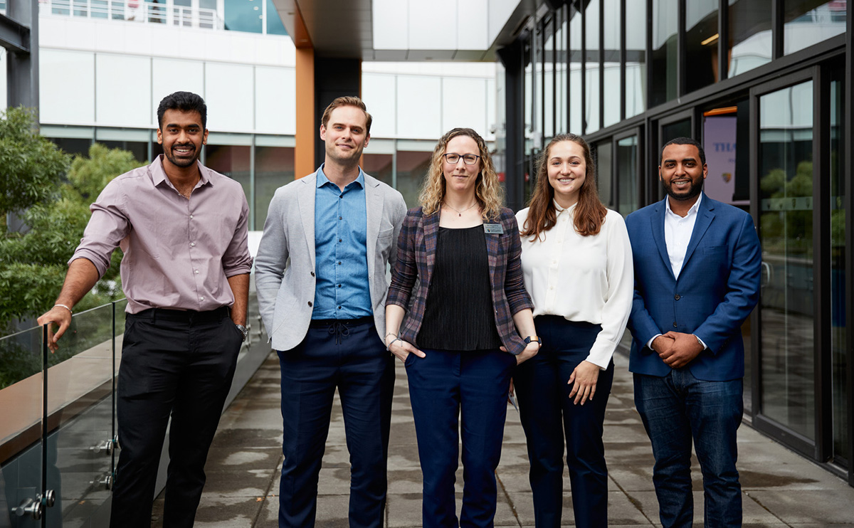 Students and alumni with Laura Kinderman, Dean of the Faculty of Business & Professional Studies