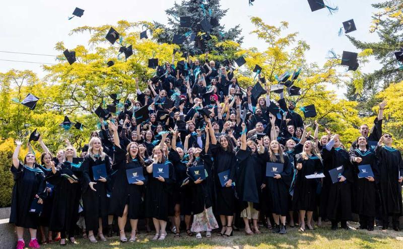 CapU students celebrating at a Convocation ceremony.