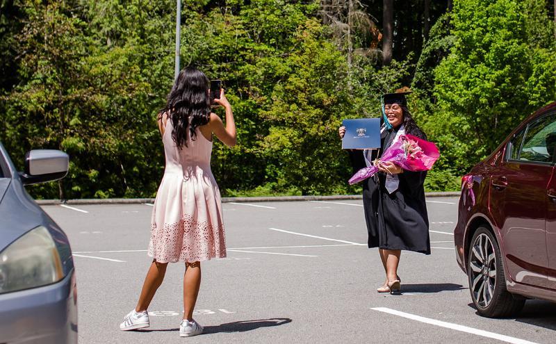 Taking photo of student with certificate 