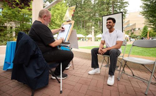 Students getting their caricatures done