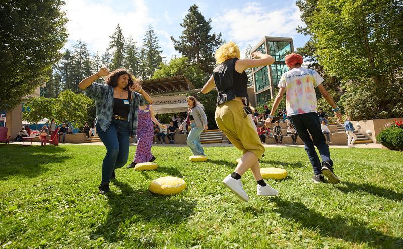 Students playing a game of musical cushions