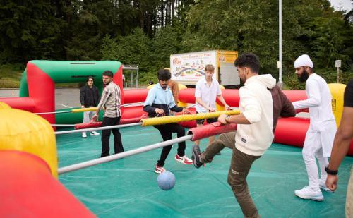 Students in an epic giant foosball battle