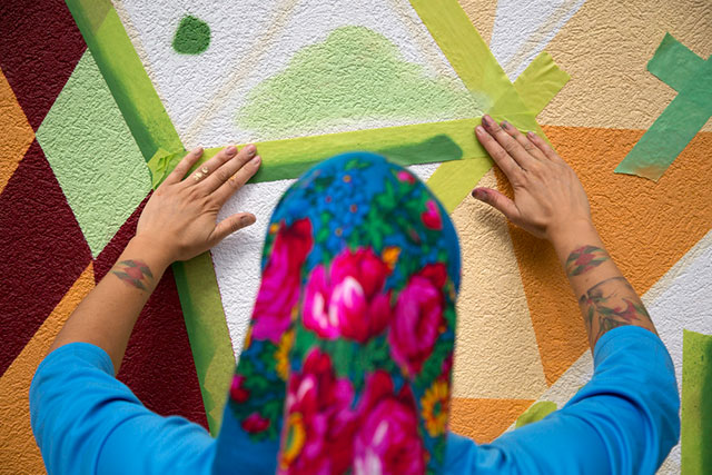 Mural artist Carrielynn Victor tapes her wall on Aug. 31, 2018. Victor was one of ten artists commissioned to create murals to celebrate Capilano University’s 50th anniversary. Check out our project (add link here to mural story) on the mural artists.