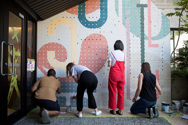 (From left) Ata Ojani, Brynn Staples, Emily Hyunh and Courtney Lamb paint their mural on Sept. 6, 2018. The IDEA School of Design students were commissioned to create one of ten murals to celebrate Capilano University’s 50th anniversary. Check out our project (add link here to mural story) on the mural artists.
