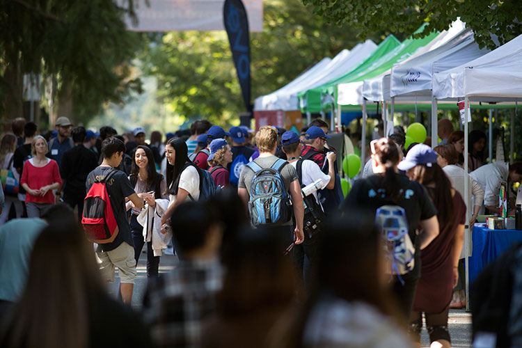 Students mingle on campus during the orientation street party on Tuesday, Sept. 4, 2018.