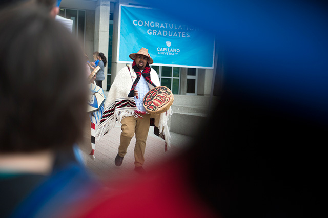 Willie Lewis, First Nations Recruitment Advisor, leads students and employees to a Convocation Ceremony at Capilano University on Tuesday, June 5, 2018.
