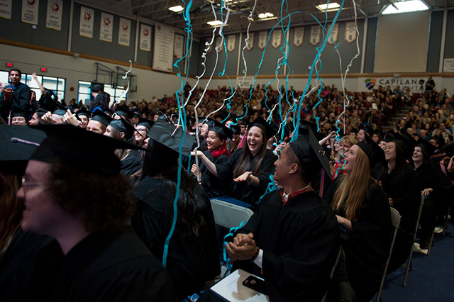 Students, families and employees celebrate at the end of a Convocation Ceremony at Capilano University on Monday, June 4, 2018.