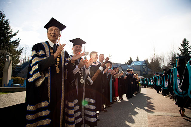 Chancellor David T. Fung, left, welcomes students during Convocation ceremonies on Feb. 21, 2020. The February ceremonies marked Fung’s last Convocation as Chancellor. (Photo by Tae Hoon Kim)