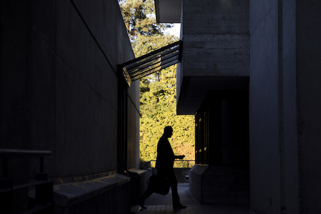 A man walks between the Birch and Arbutus buildings on March 16, 2020.