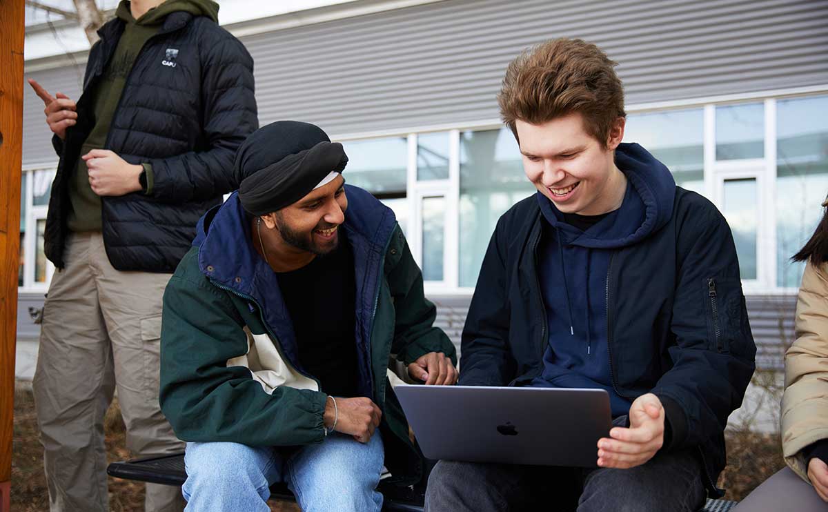 CapU students working together outside.