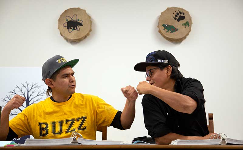 Students at the Ts'zil Learning Centre fist bumping.