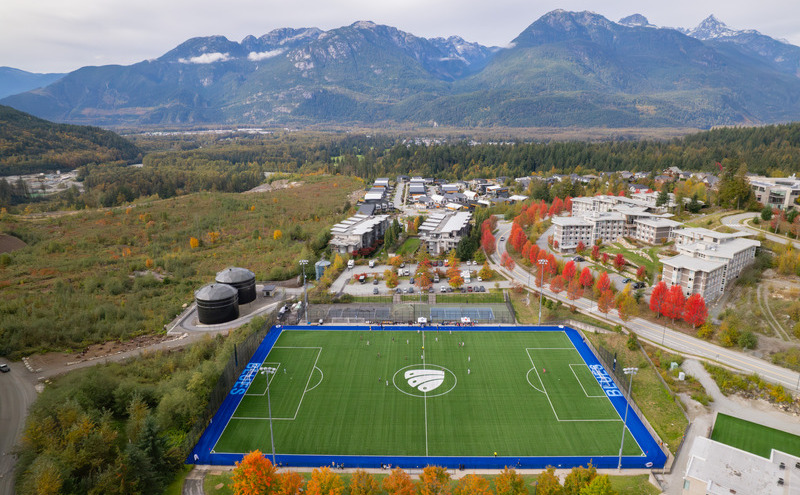 A view of CapU Squamish from above showing the campus and soccer field