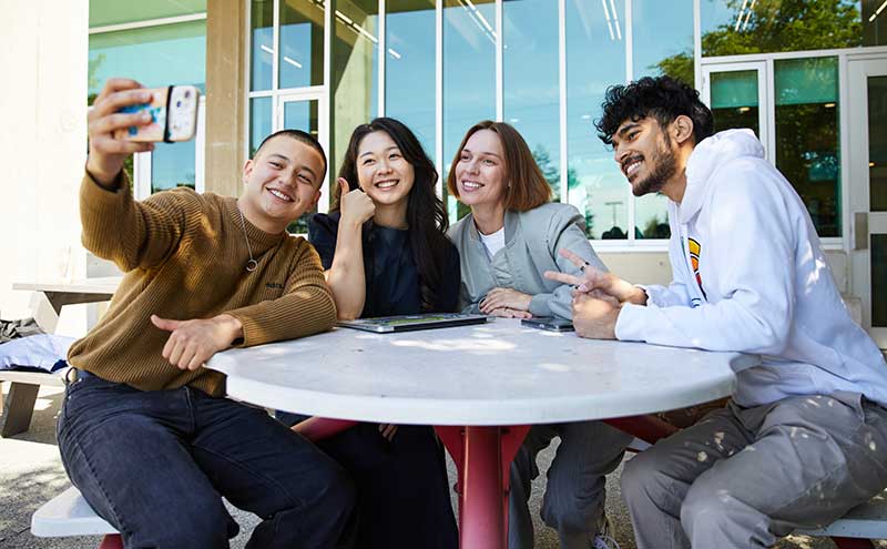 CapU students sitting together at North Vancouver Campus.