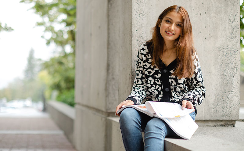 Student sitting outside of Birch Building