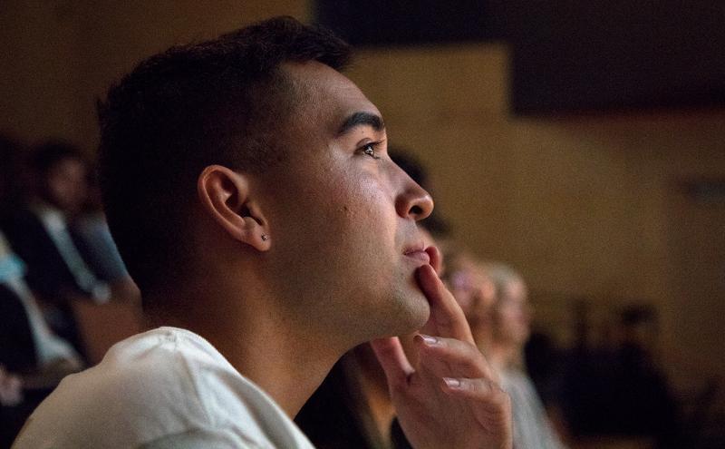 Student in audience listening to presentation