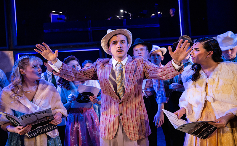 Students performing in a theatre