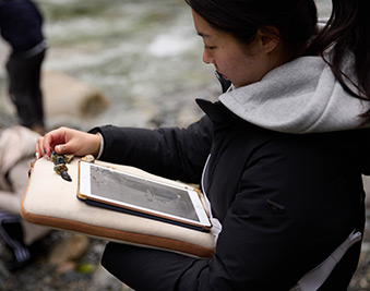 CapU geography student working on a tablet.