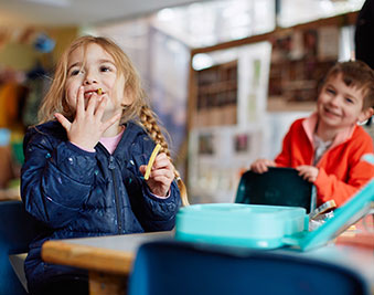 Two children having a snack.