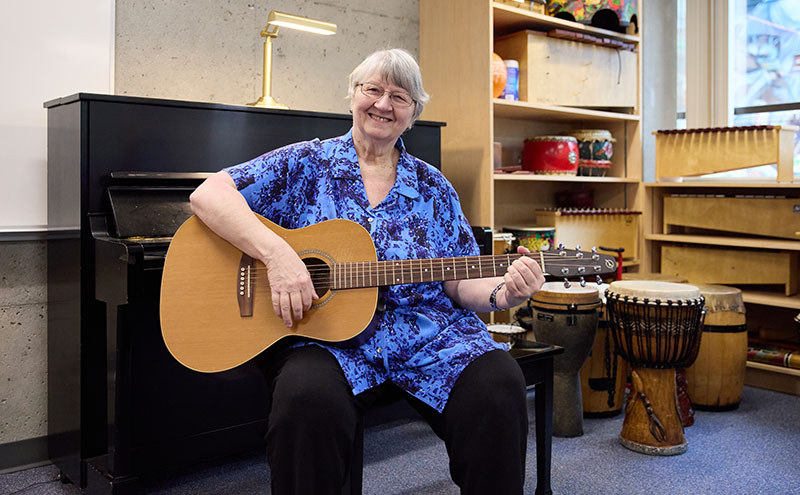 CapU Music Therapy grad Susan Summers with a guitar.
