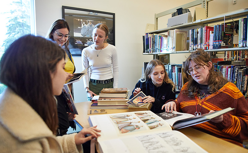 CapU costuming students in the Costuming Library.