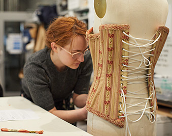 CapU costuming student working on a corset.