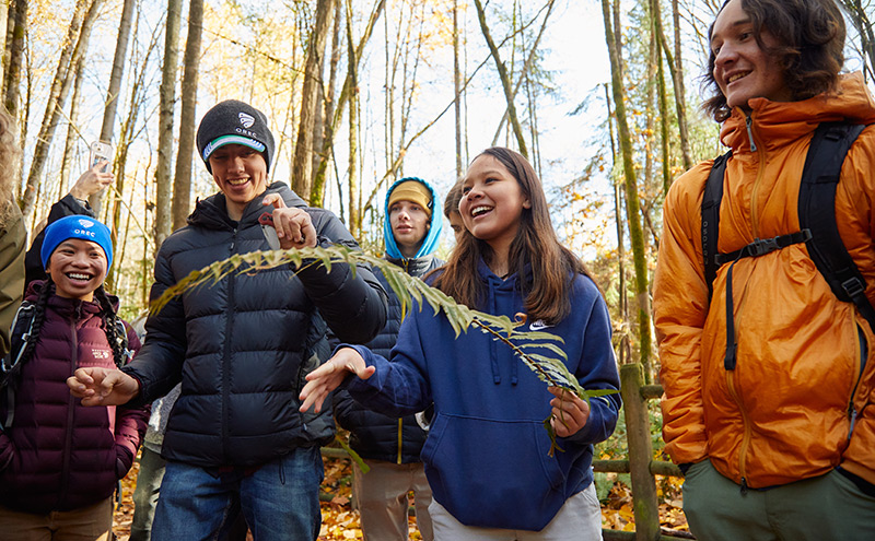 CapU Outdoor Recreation Management students holding a fern on a trip to Mosquito Creek.