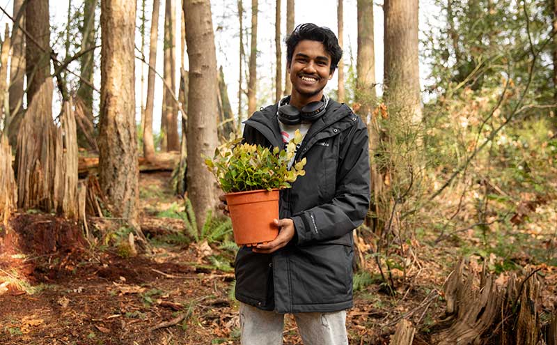 CapU student with a plant during UN Sustainable Development Goals Week.