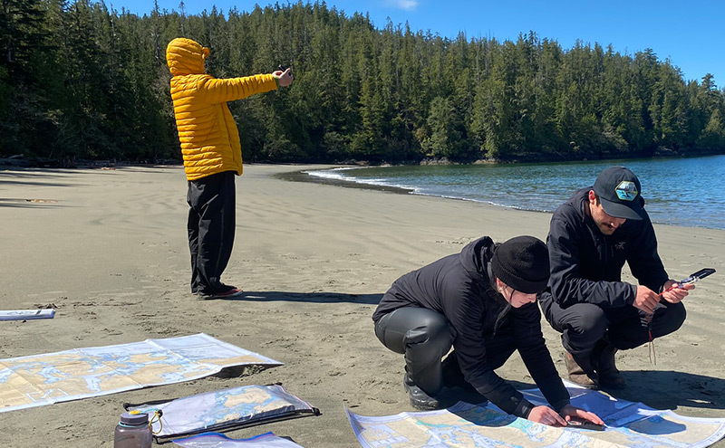 CapU OREC students looking at a map.