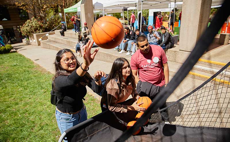 CapU students playing basketball at Orientation.