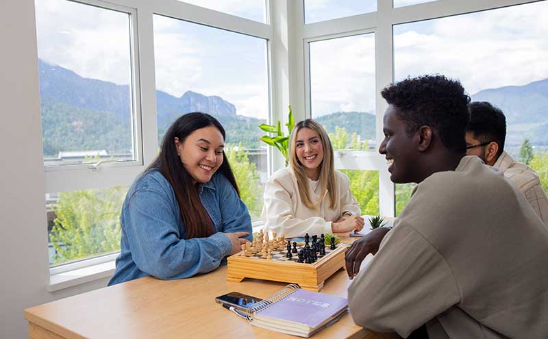 Students in Squamish residence playing a board game.