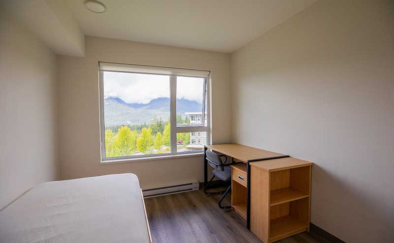A basic room in student housing at CapU Squamish campus.